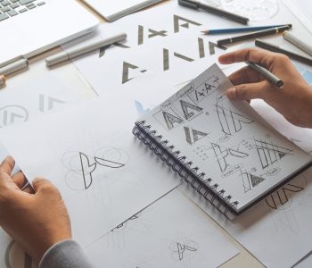 Photo of many logo variations and the development of a logo